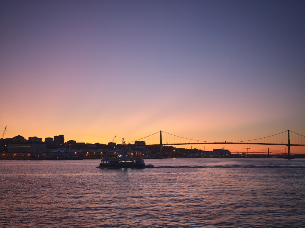 Nova Scotia skyline at dusk on the water with a boat in the distance image
